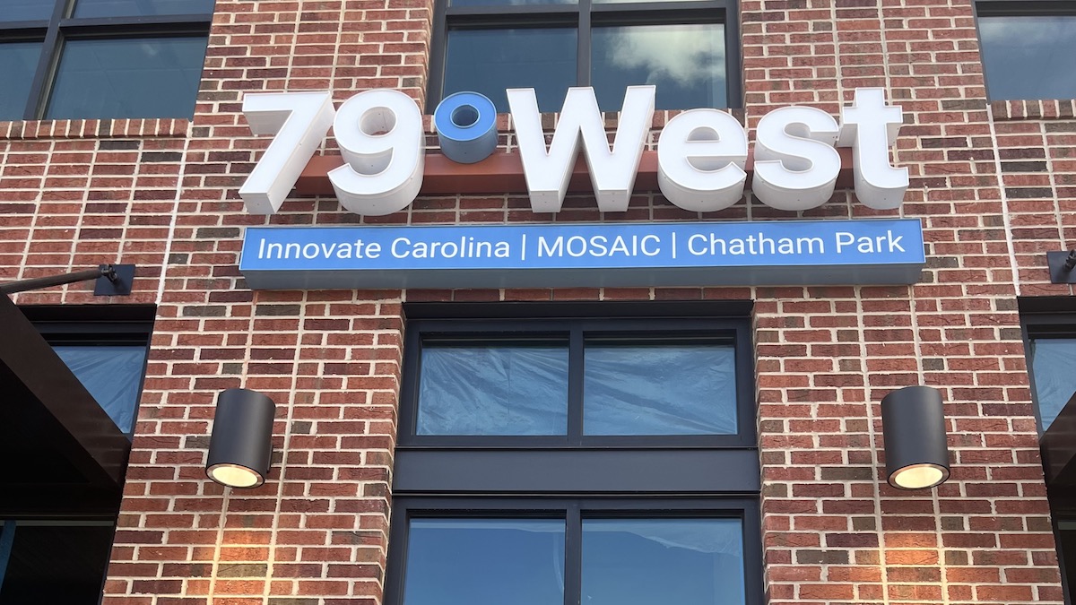 Photo of 79 West sign on the front of brick building.