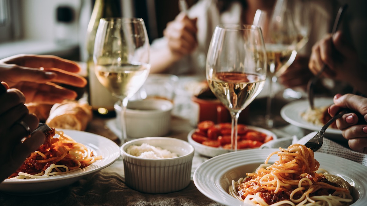Table set with pasta and wine at a Tavolo Italian Restaurant at MOSAIC at Chatham Park