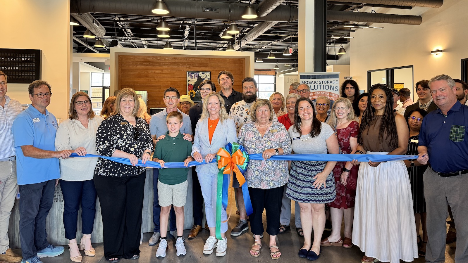 People at a ribbon cutting in an office