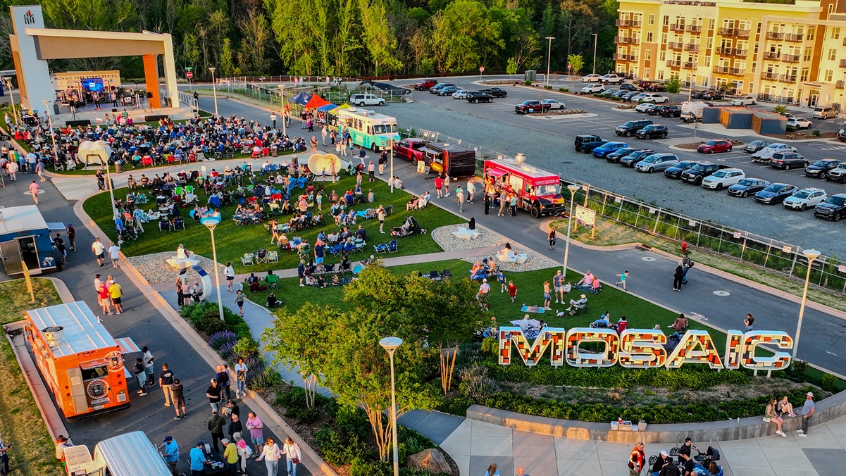 An outdoor concert on an event lawn with food trucks at MOSAIC in Pittsboro, NC