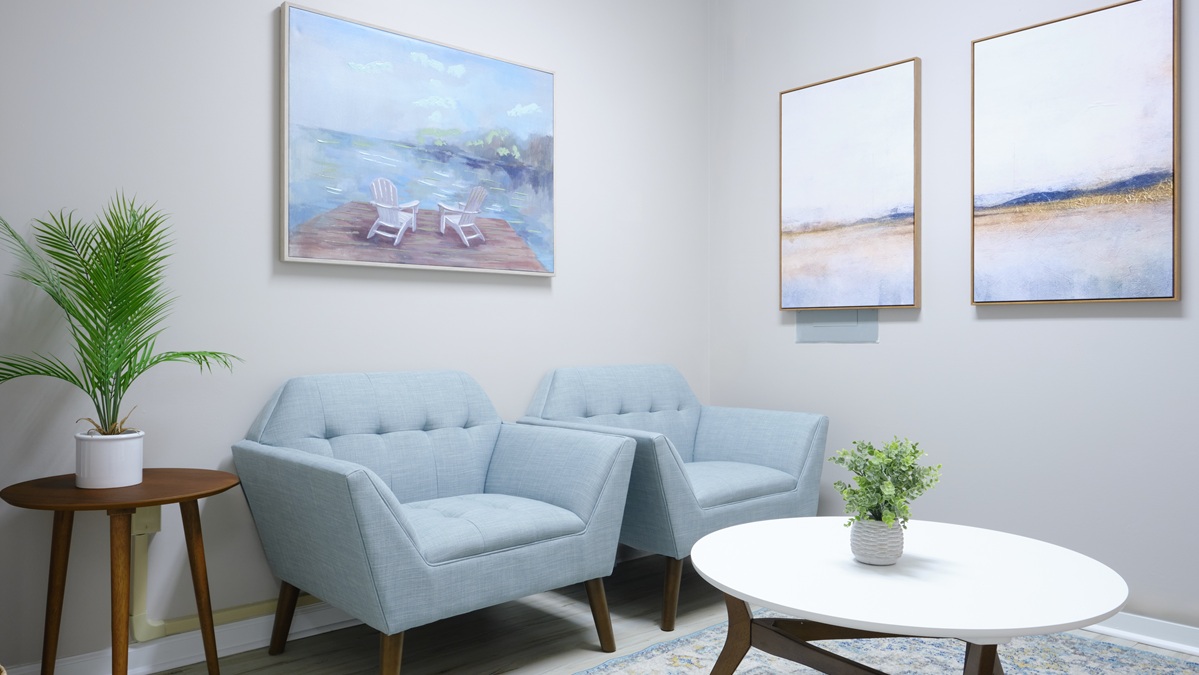 Two chairs and coffee table in waiting room at Foundations Family Therapy at MOSAIC