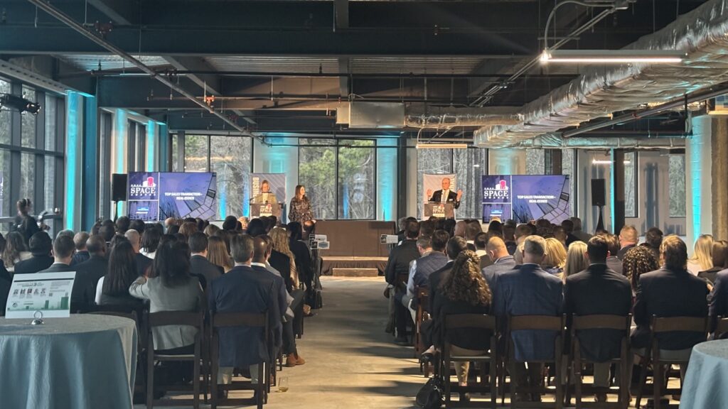 Award show with many people seated in front of speaker