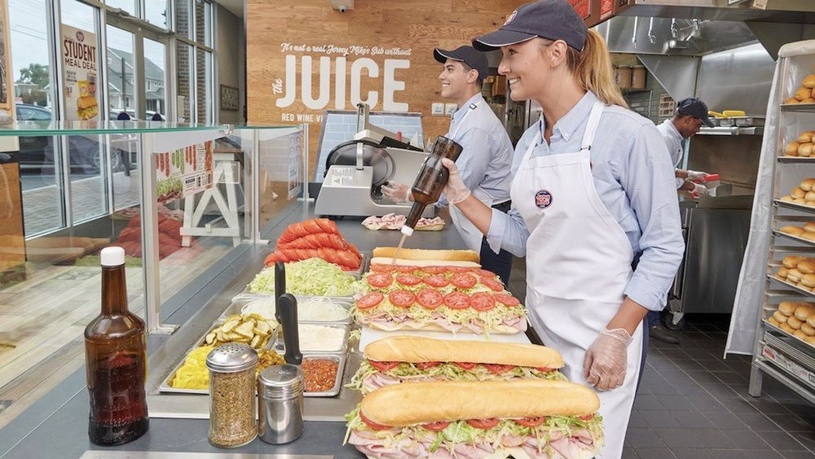 Two people working at Jersey Mike's counter.