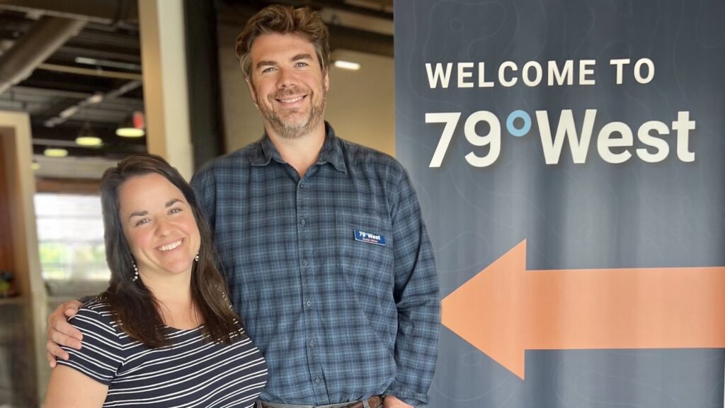Katie & Dustin Miller pose in front of 79West sign.