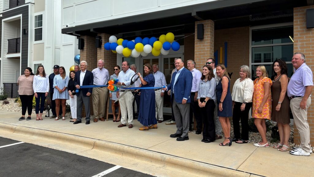 People standing in line in front of apartment building