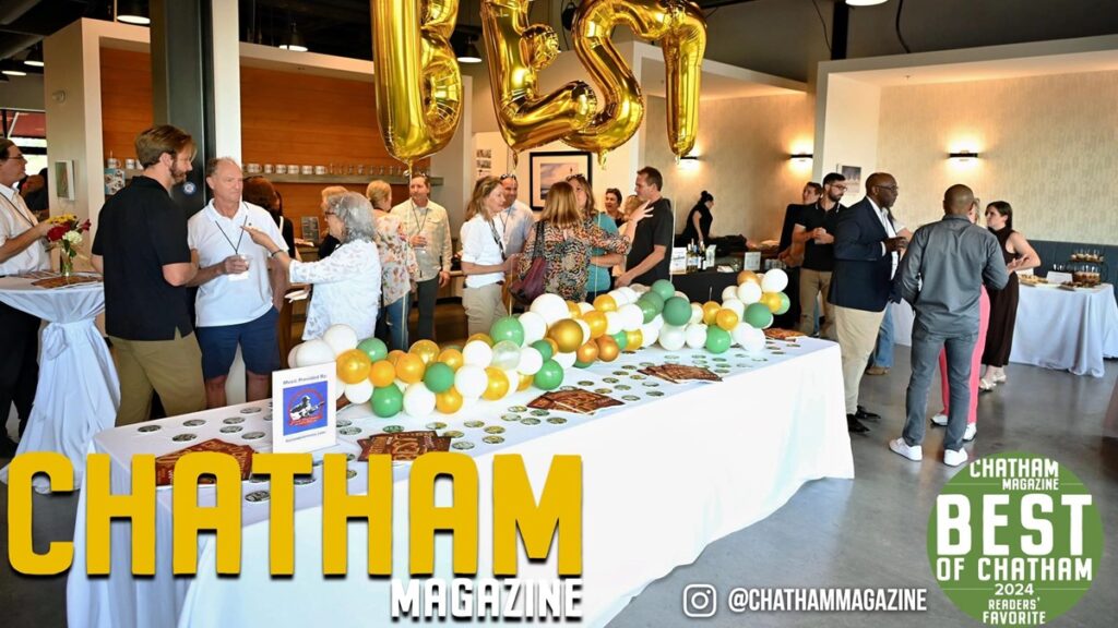 Party with people standing around talking and eating.