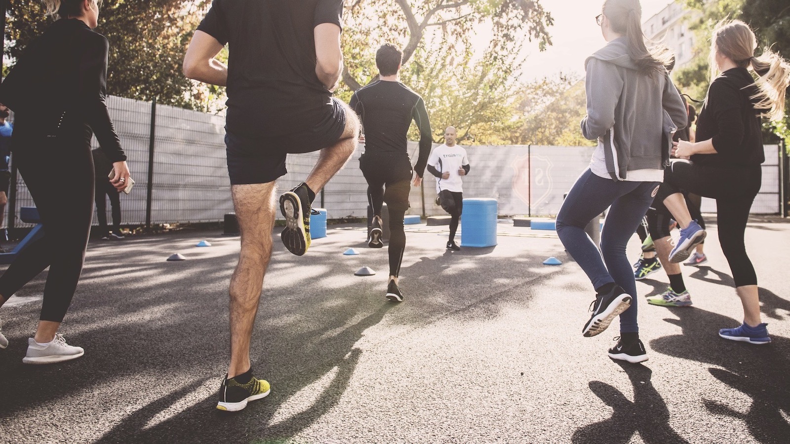 Men and women exercising outside.