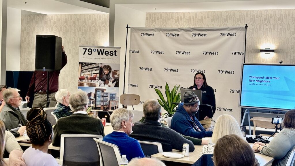 Wolfspeed presenters deliver a presentation at 79West to an audience-filled room.