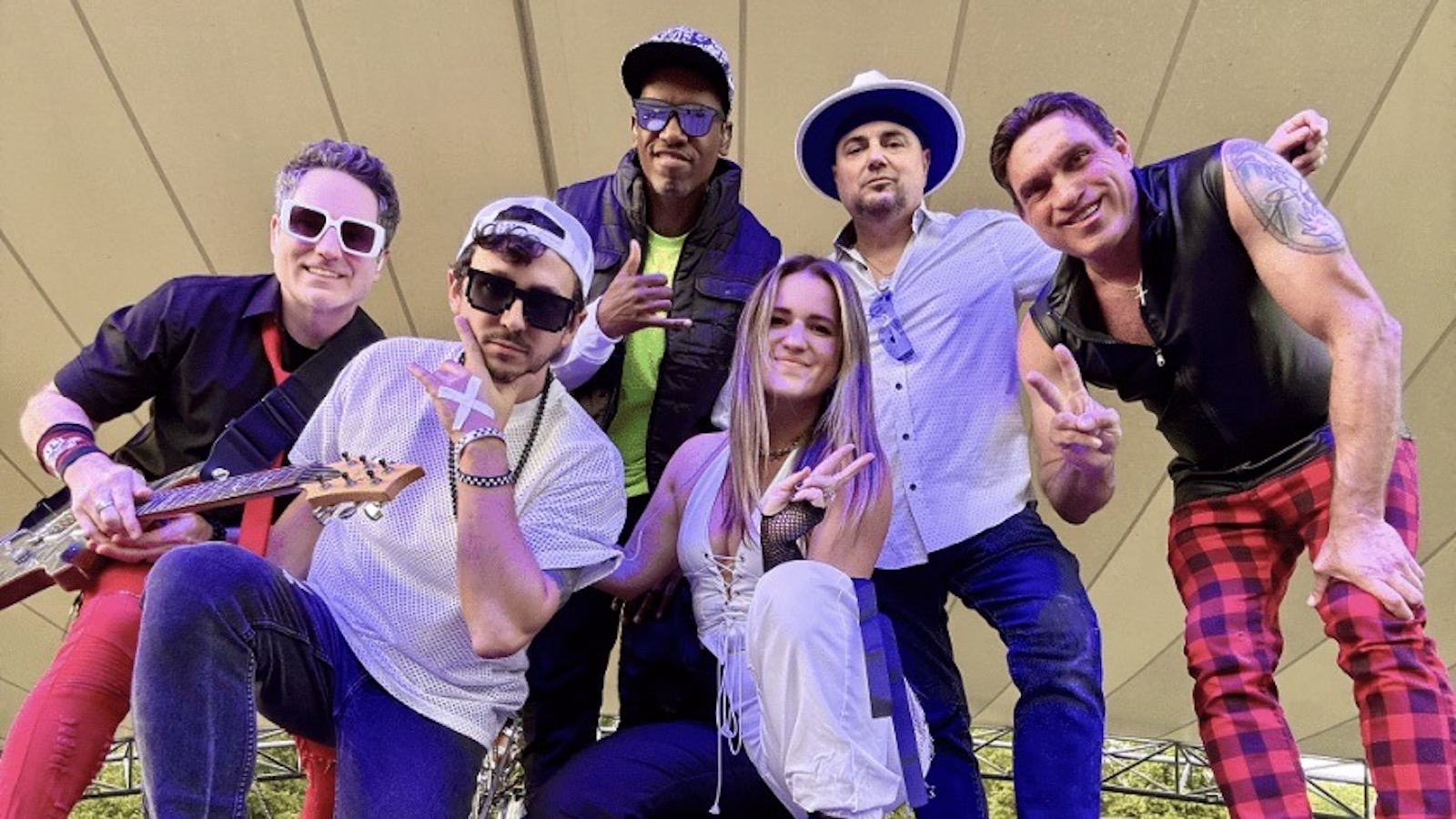 Members of the Y2K Kids band pose on stage.